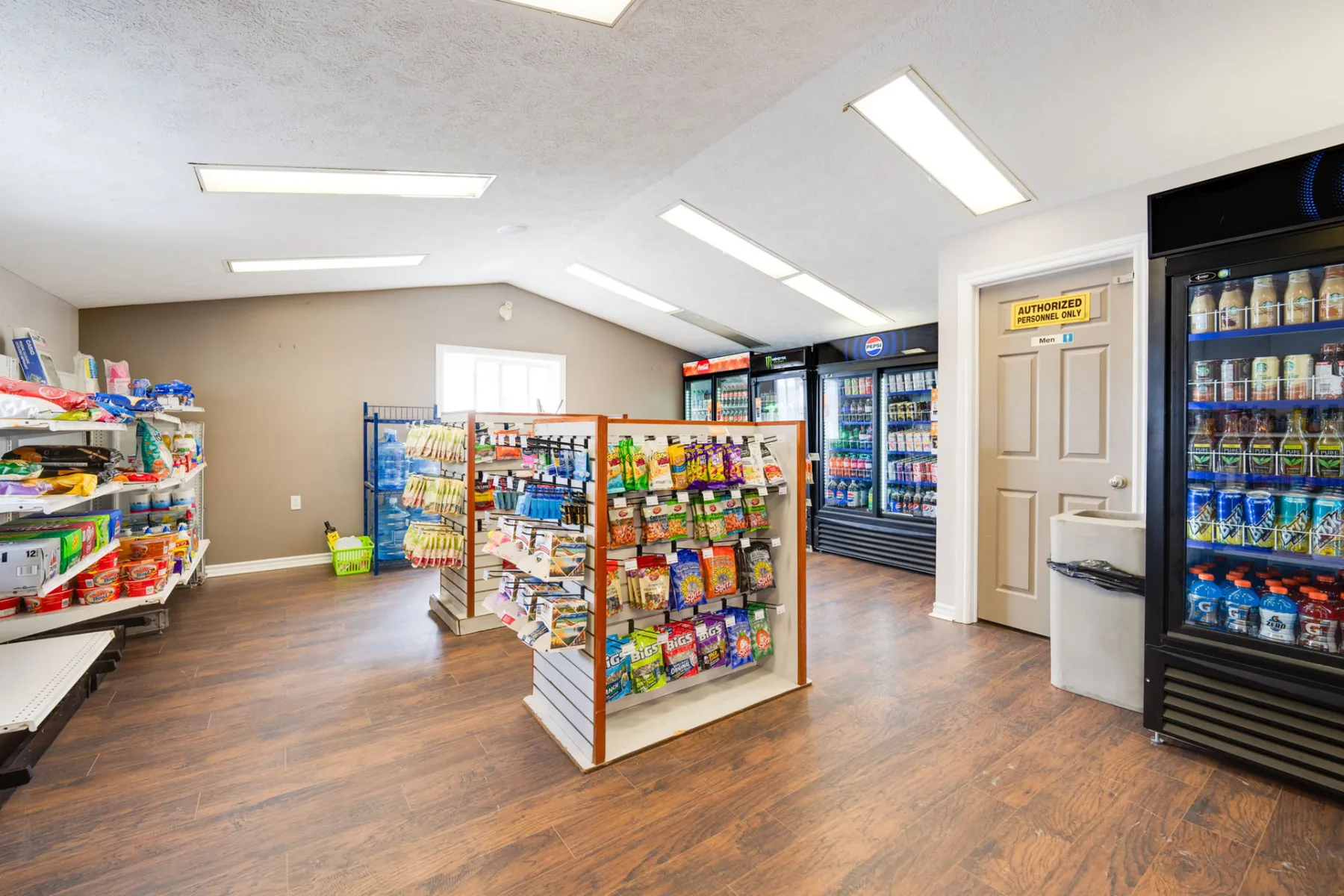 Convenience store interior with coolers and shelving